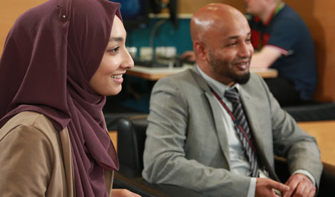 Two non-exam assessment advisers working at a desk