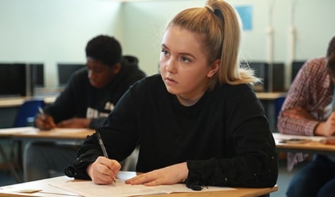 GCSE student at a desk